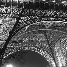 The lower portion of the north side of the Eiffel Tower at night.