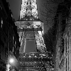 The east side of the Eiffel Tower seen from rue de l’Université at night.