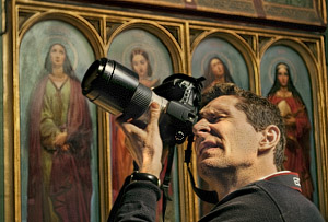 A photography workshop participant taking picture inside a church in Paris.