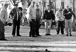 Some men playing “pétanque”, the French version of bocci, or English bowles, in place de la Nation, Paris.