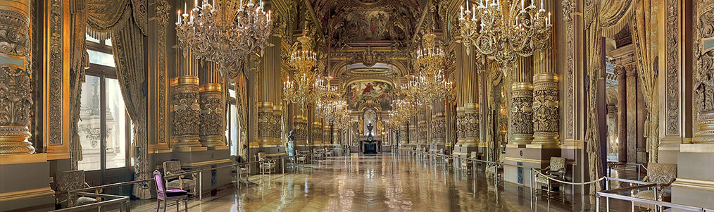 A copy of a sculpture of Charles Garnier by Jean-Baptiste Carpeaux stands in the middle of the foyer, next to one of the windows looking over avenue de lOp&eacute;ra towards the Louvre.