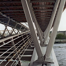 Structural pillars, beams and stairs under the Solférino footbridge.