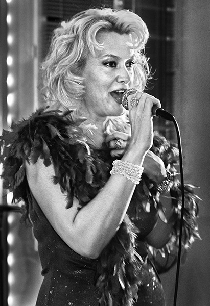 A black and white photographic portrait of Luana Lavyy Goldstar taken at the Swan Bar in Paris, by David Henry.