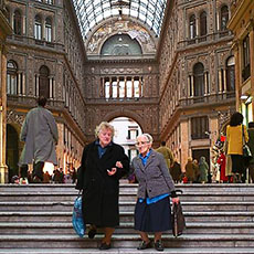 Two women walking out from the Galleria Umberto I in Naples.
