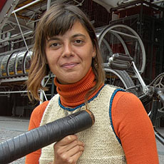 A young woman with her didgeridoo in front of the Pompidou Center.
