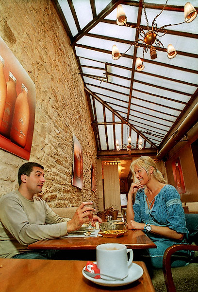 A man and a woman having coffee in Les Bains du Marais.