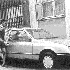 A woman destroying a car with her hands and feet in cour de la Ferme-Saint-Lazare.