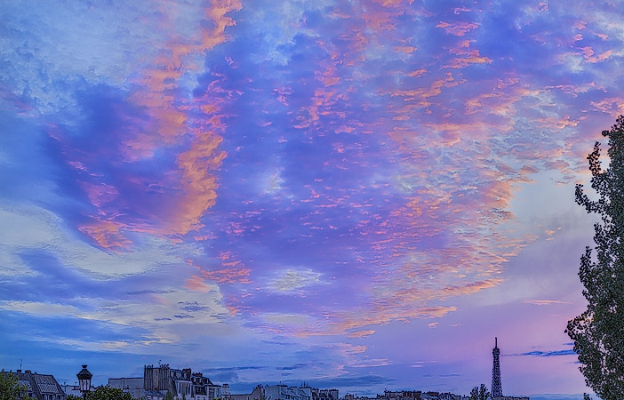 Un coucher de soleil rose et violet derrière la tour Eiffel