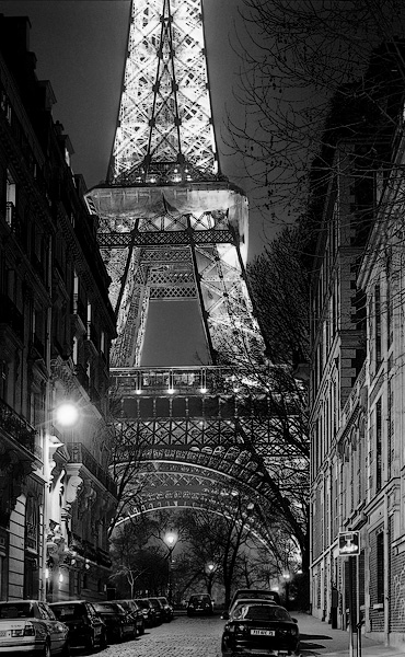 The east side of the Eiffel Tower seen from rue de l’Université at night.