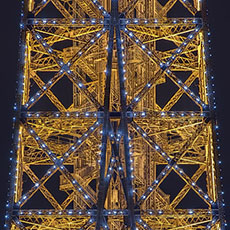 Flashing white lights on the Eiffel Tower at night.