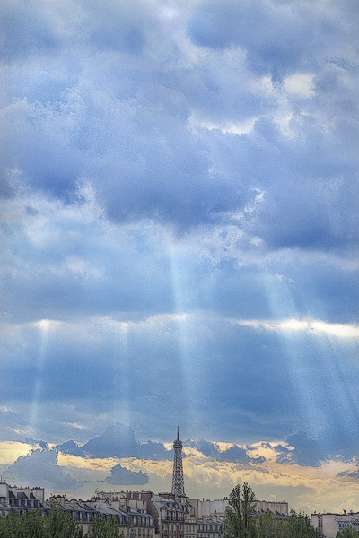 Shafts of light shining down on the Eiffel Tower.