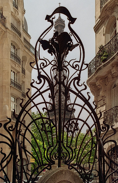 The Eiffel Tower behind the iron entrance gate at square Rapp.