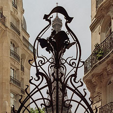 The Eiffel Tower behind the iron entrance gate at square Rapp.