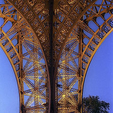 The south pillar of the Eiffel Tower at night.