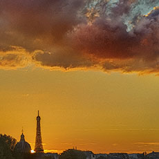The sun setting on the Eiffel Tower and l’Institut de France, seen the Right Bank.