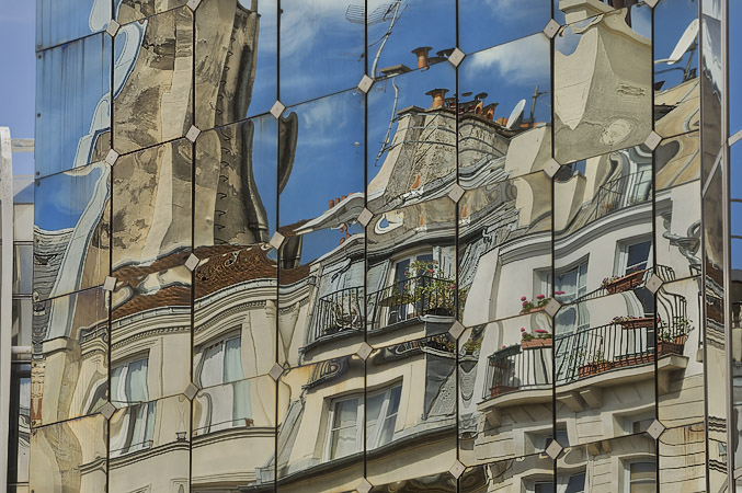 Reflections of buildings on rue Rambuteau in the windows of le Forum des Halles.