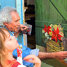 Un artiste avec des enfants devant son studio sur la rue Saint-Marthe.