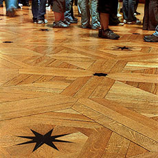 Stars embedded in the wood floor of the Grande Galerie inside the Louvre Museum.