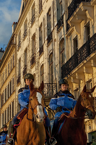 Three members of the Garde Républicaine riding their horses on quai de Bourbon on île Saint-Louis.