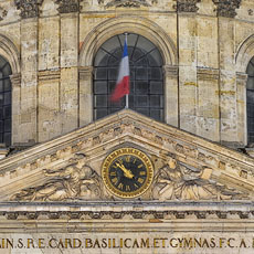 The pediment and lower half of the dome of l’Institut de France at night.