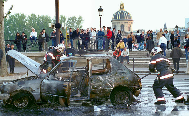 The burnt hulk of a car after burning on quai du Louvre.