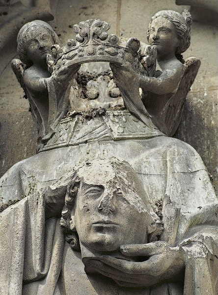 A statue of Saint-Denis on the south façade of Notre-Dame.