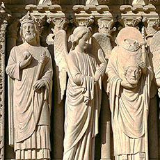 Sculptures of four saints, including Saint-Denis on the main façade of Notre-Dame.