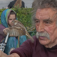 Pierre Pradeau feeding sparrows in front of Notre-Dame Cathedral.