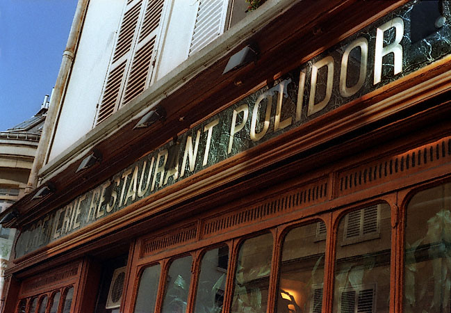 The sign and upper façade of the Crémerie Restaurant Polidor.