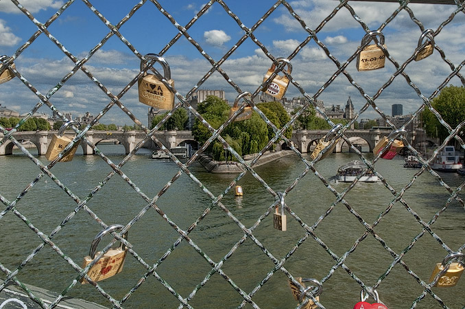 Padlocks attached to the fence on the east side of pont des Arts.