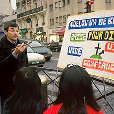 An evangelist preaching with his painting on boulevard de la Villette.