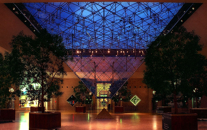 The Carrousel du Louvre’s Inverted Pyramid seen from outside at night.