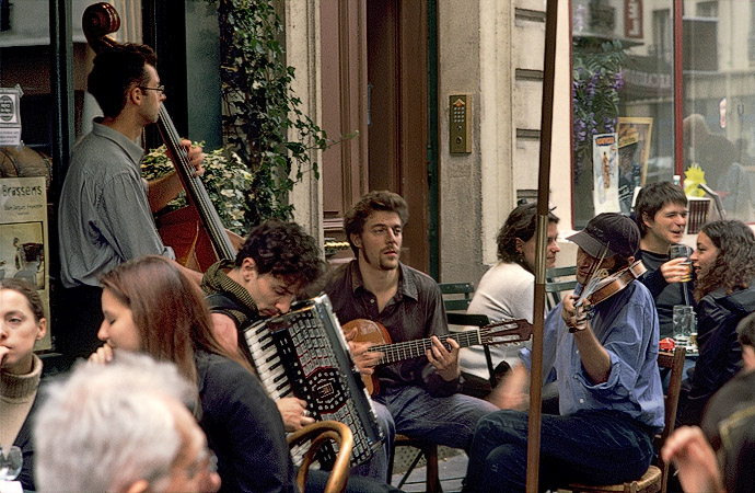 Three musicians playing in front of le Bistrot des Oies on rue Marie-et-Louise.