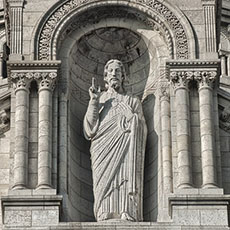 The statue of Jesus Christ on the main façade of Basilica Sacré-Cœur.