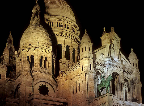 The main façade of Sacré Cœur Basilica at night.