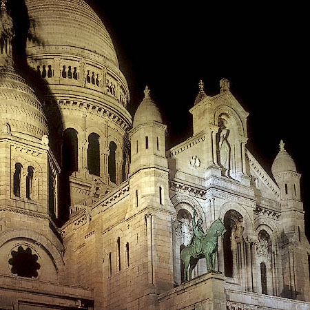 The main façade of Sacré Cœur Basilica at night.