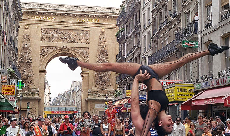 Acrobats performing in a street festival on rue du Faubourg-Saint-Denis.