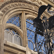 Windows on the Adyar Theater’s façade and the wrought-iron gateway to square Rapp.