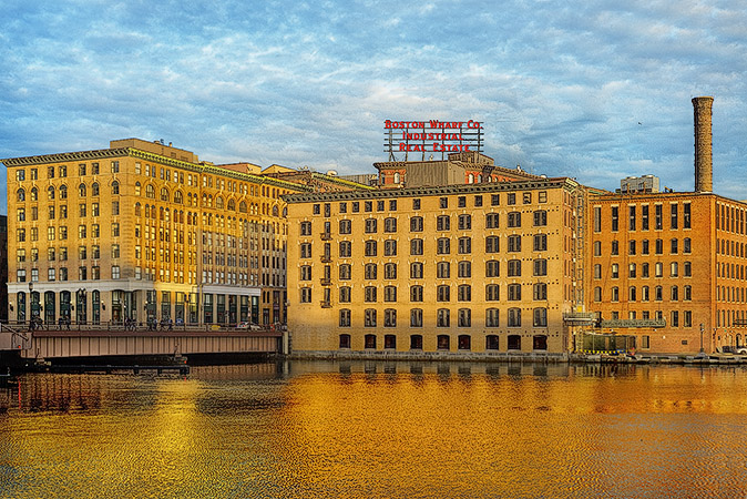 Buildings along Summer Street on the Fort Point Channel waterfront at sunset.