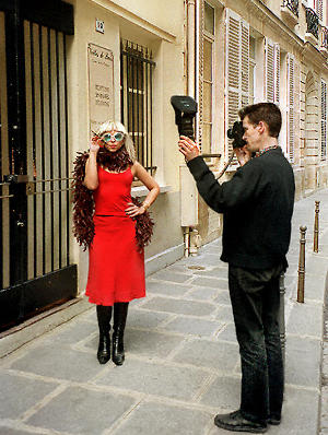 A photographer taking pictures of a young woman in Paris.