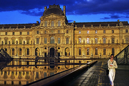 The courtyard of the Louvre Museum at sunset.