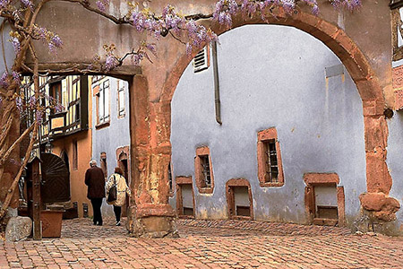An archway leading off from Riquewihr’s main street in Alsace-Lorraine.