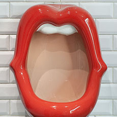 A urinal in the shape of a woman’s mouth in the men’s at the Belushi’s bar in Paris.