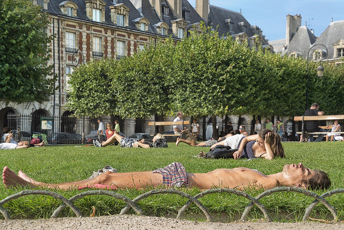 A young man with an erection visible through his shorts in place des Vosges.