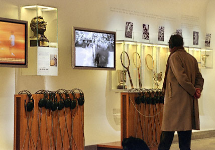 A man watching videos inside the Tenniseum in Paris.