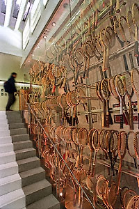 A wall of tennis racquets at the Roland Garros Tenniseum