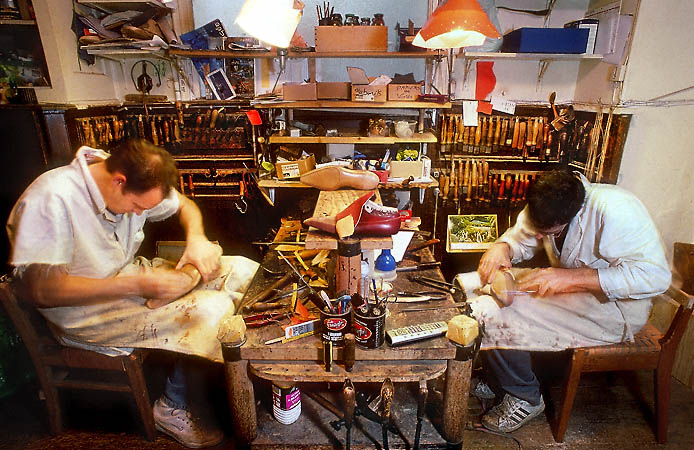 Two cobblers making shoes in Pierre Corthay’s workshop.